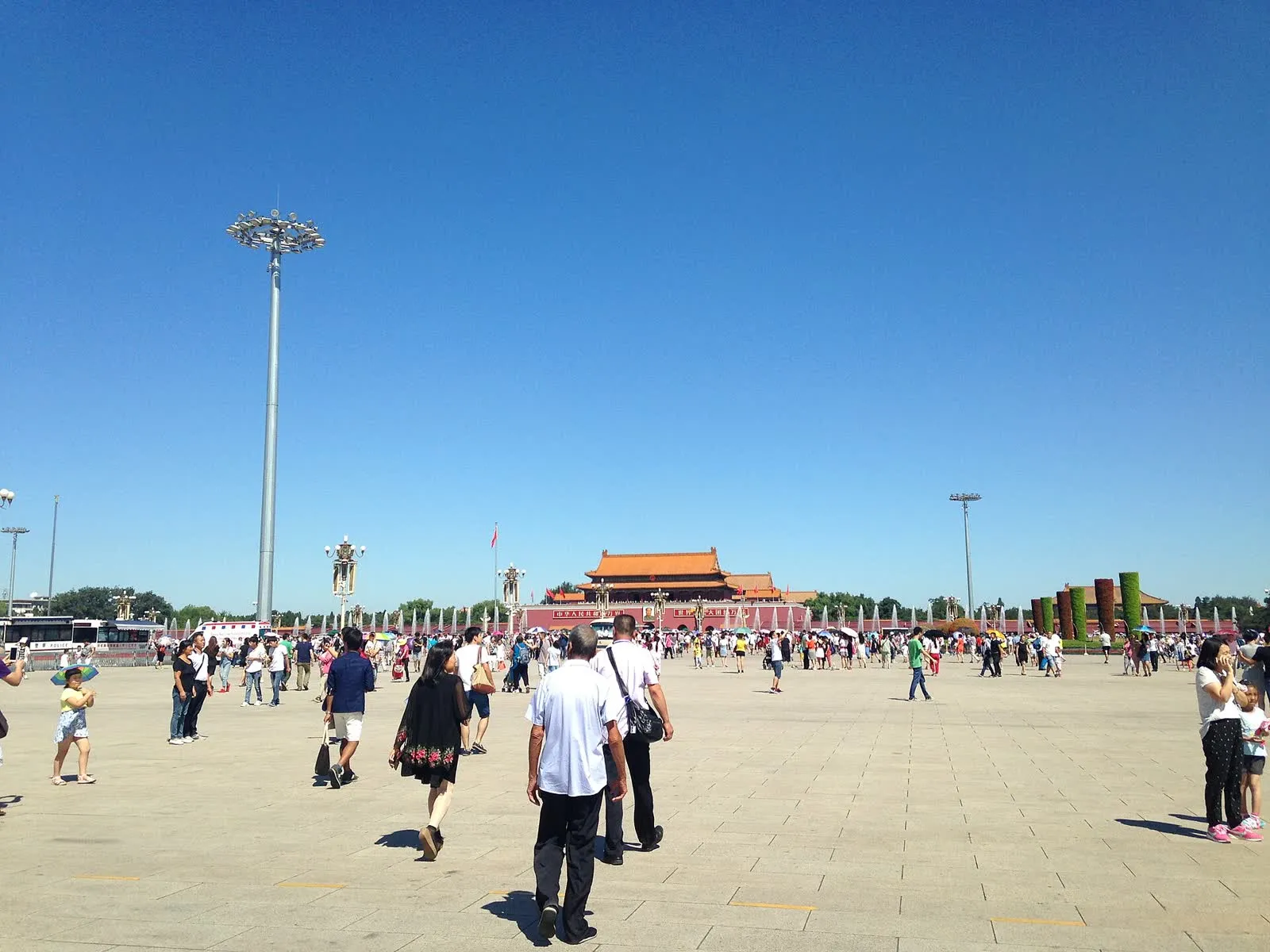 Tiananmen Gate seen from Tiananmen Square, with visitors walking across the square