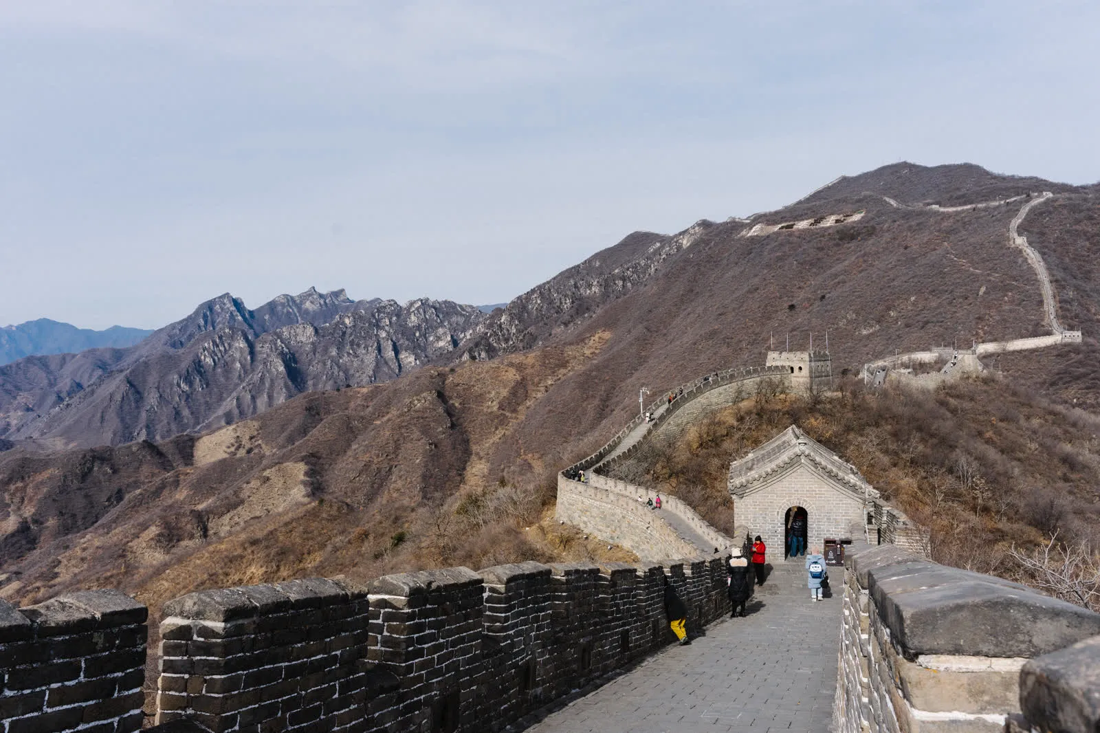 A paved walkway along the top of the Mutianyu Great Wall between watchtowers